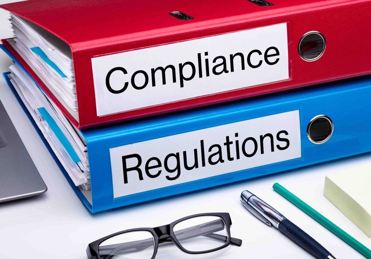 Compliance And Regulation With Office Supplies Over Business Desk
